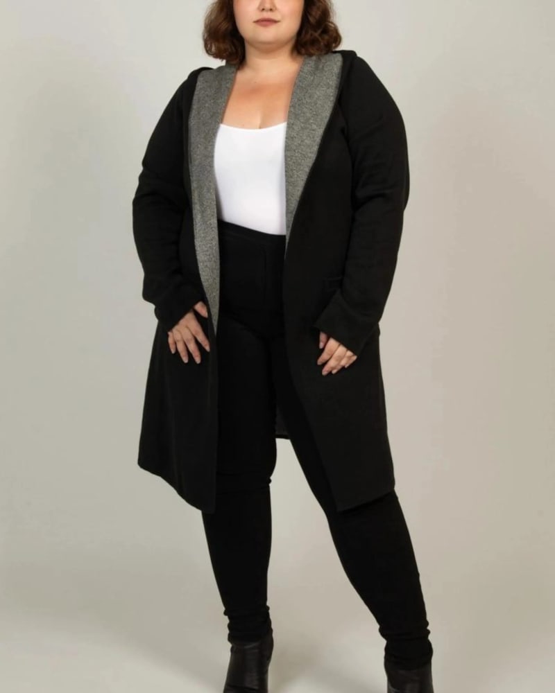 Front of a model wearing a size XL Nora Hooded Open Front Knit Cardigan Black in Black by ANNICK. | dia_product_style_image_id:309330